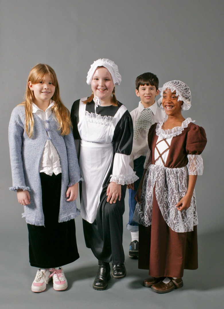 Three girls and 1 boy wearing historical clothes