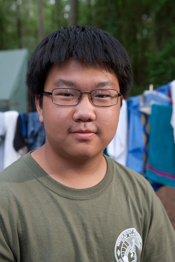 A boy in a green shirt with glasses