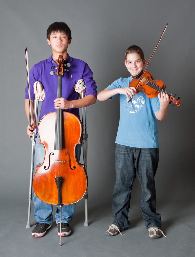 a boy holding a cello