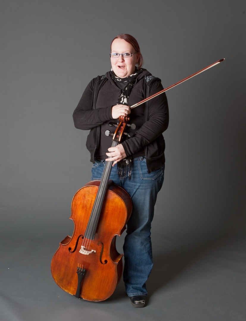 A girl with a black scarf holding a cello