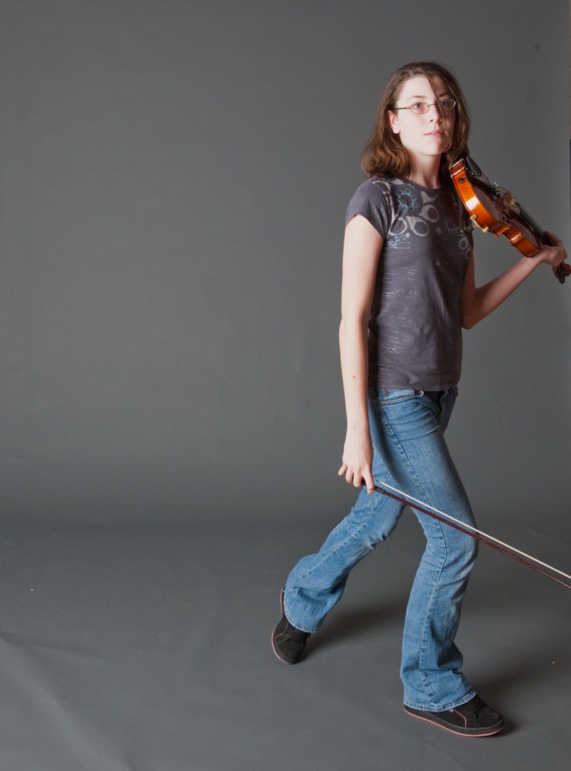 a girl holding a violin