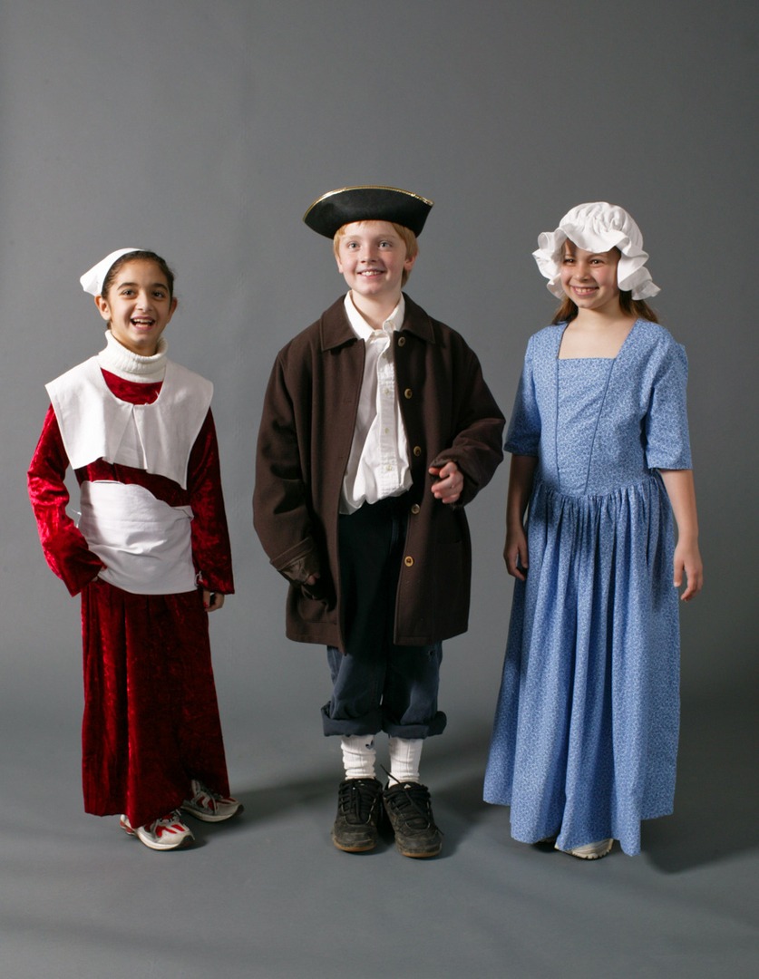 Three children wearing historical clothes