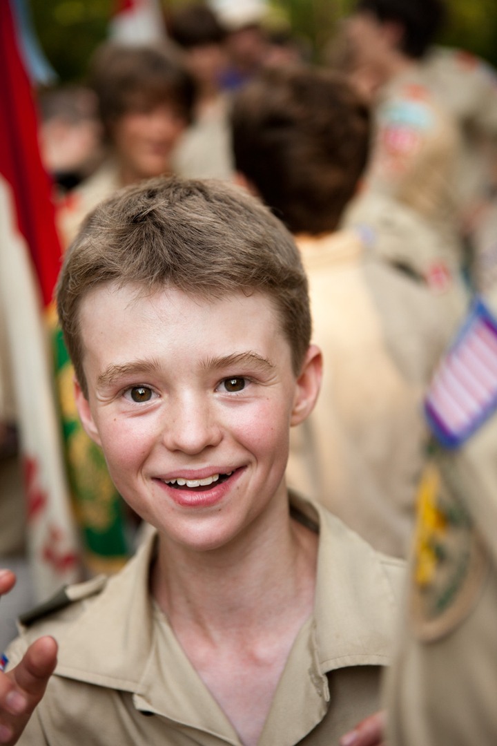 A boy in a parade smiling