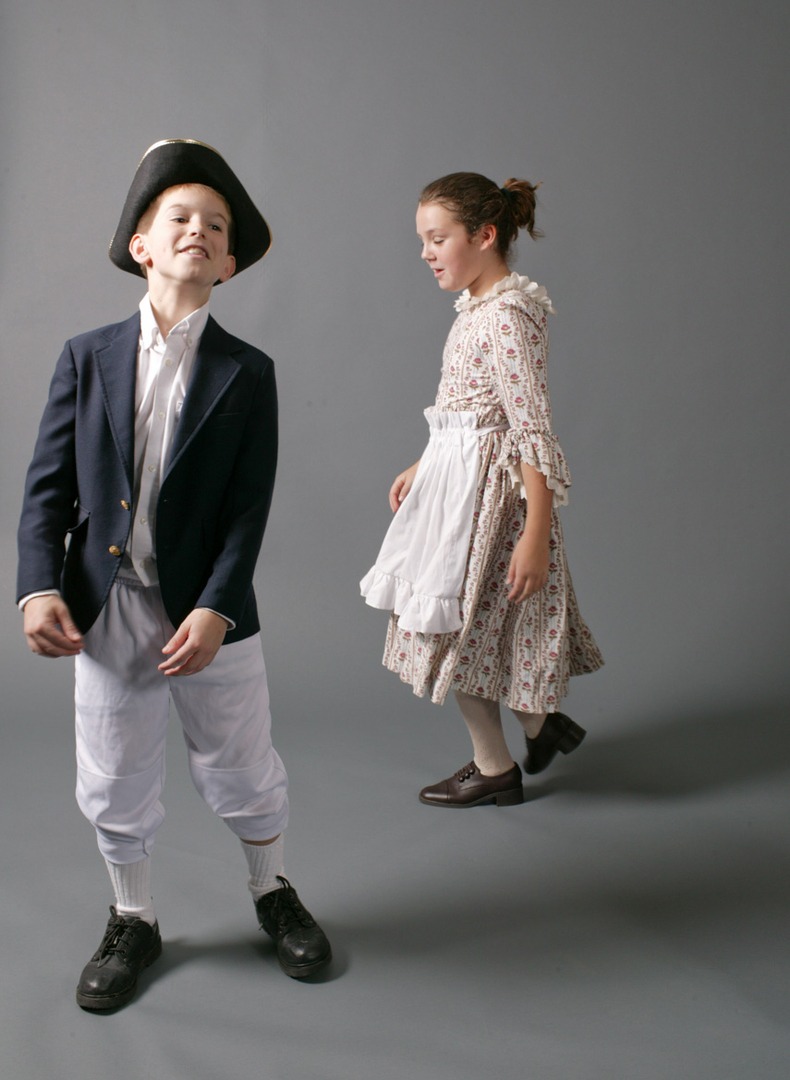 A boy with a cap and a girl with an apron