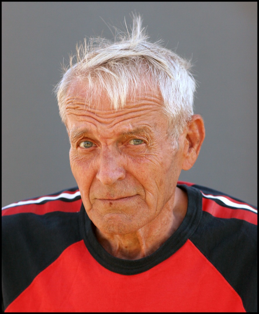 A close up picture of a man in a red and black shirt