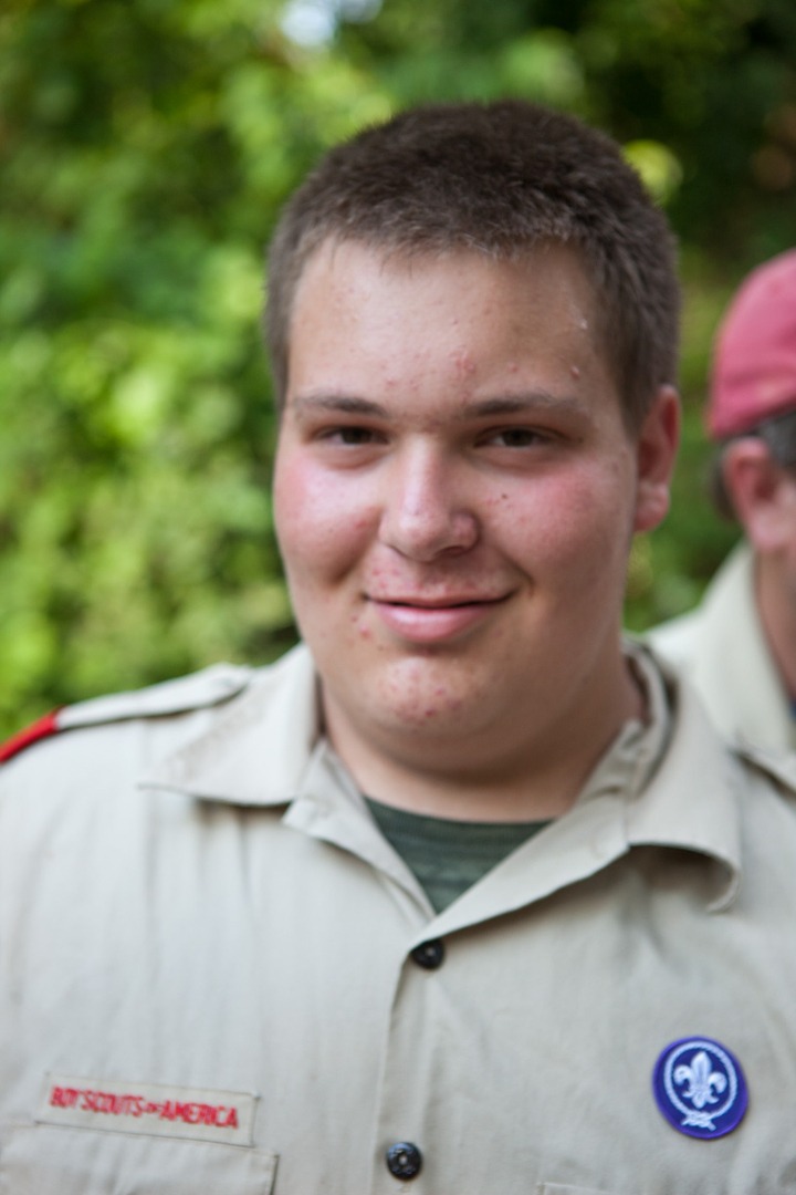 A boy wearing a uniform of the boy scouts of america