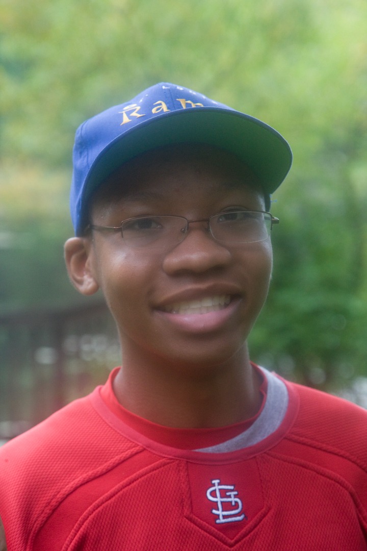 A boy with the blue cap smiling