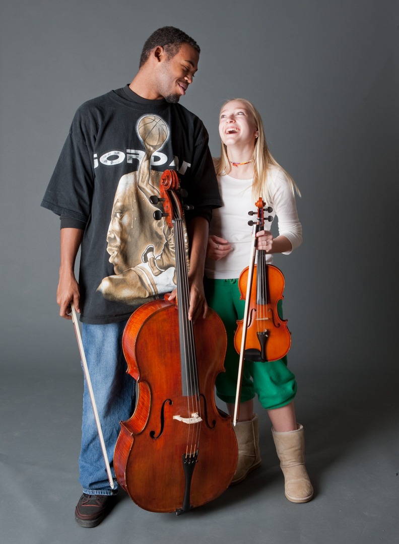 a couple holding musical instruments