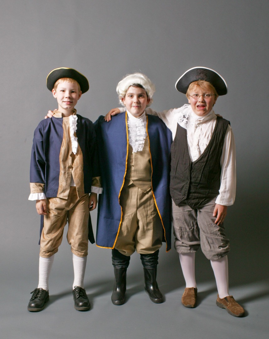 three children in historical clothes and one with glasses