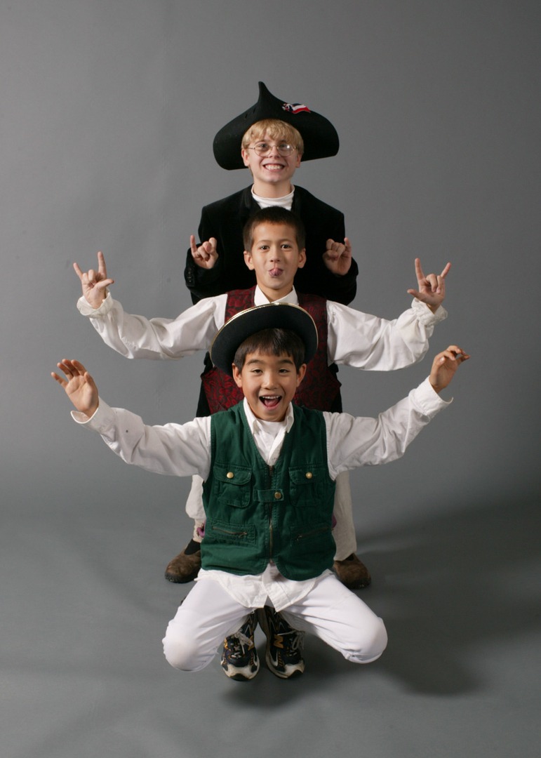 An image of three children lining up