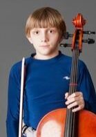 A boy on a blue shirt with an instrument